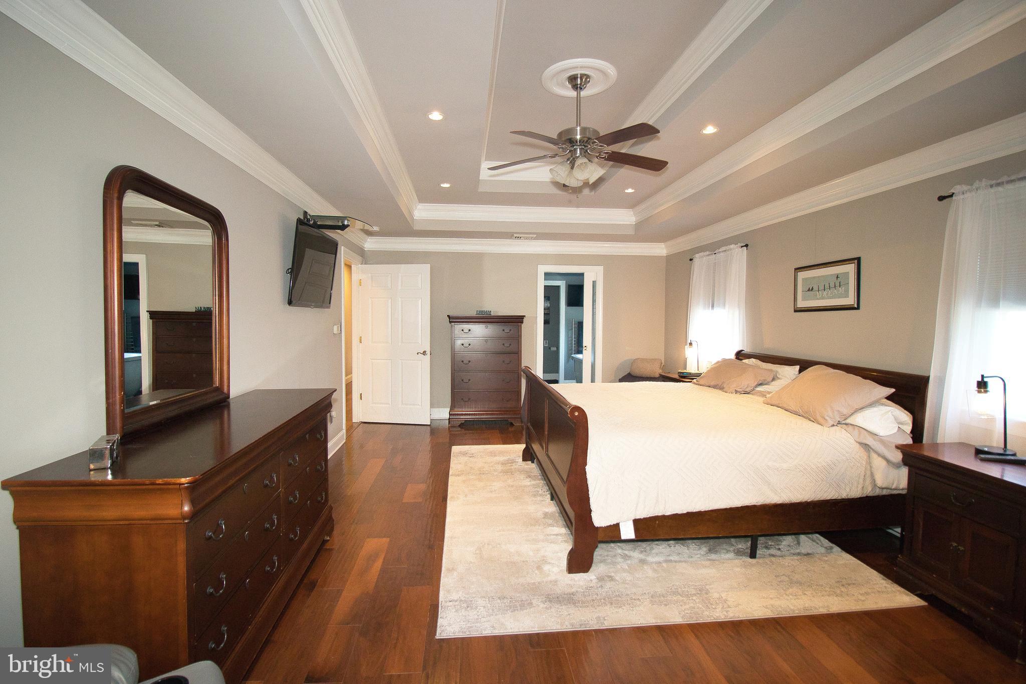 136 Washington Drive Warminster, PA 18974 - Photo 17 of 39 a spacious bedroom with a bed and dresser with mirror