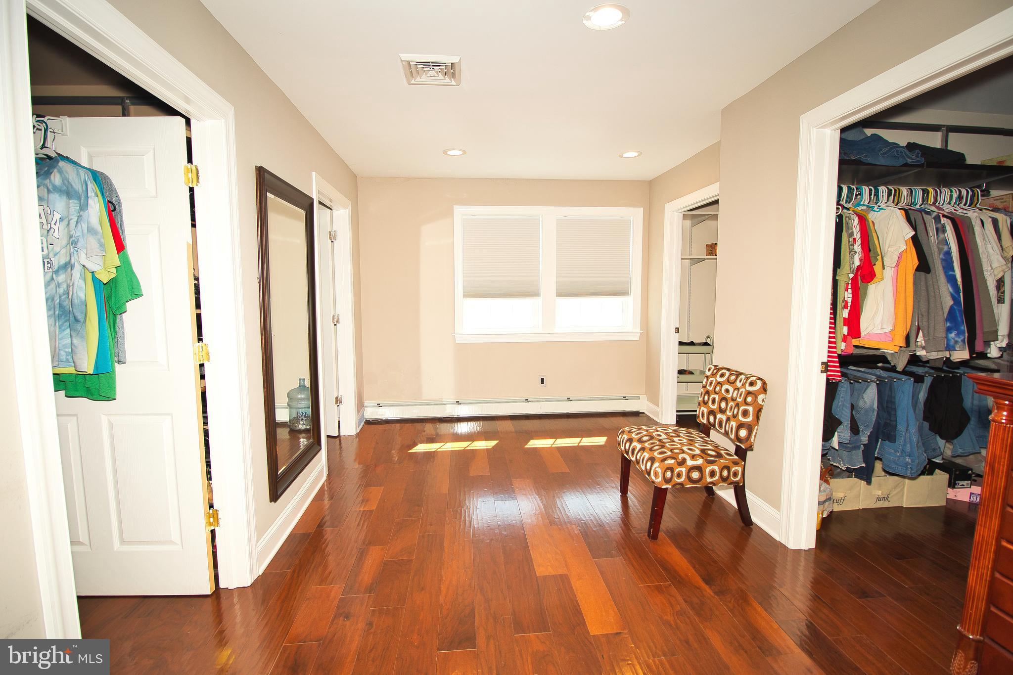 136 Washington Drive Warminster, PA 18974 - Photo 19 of 39 a view of a hallway with wooden floor and furniture