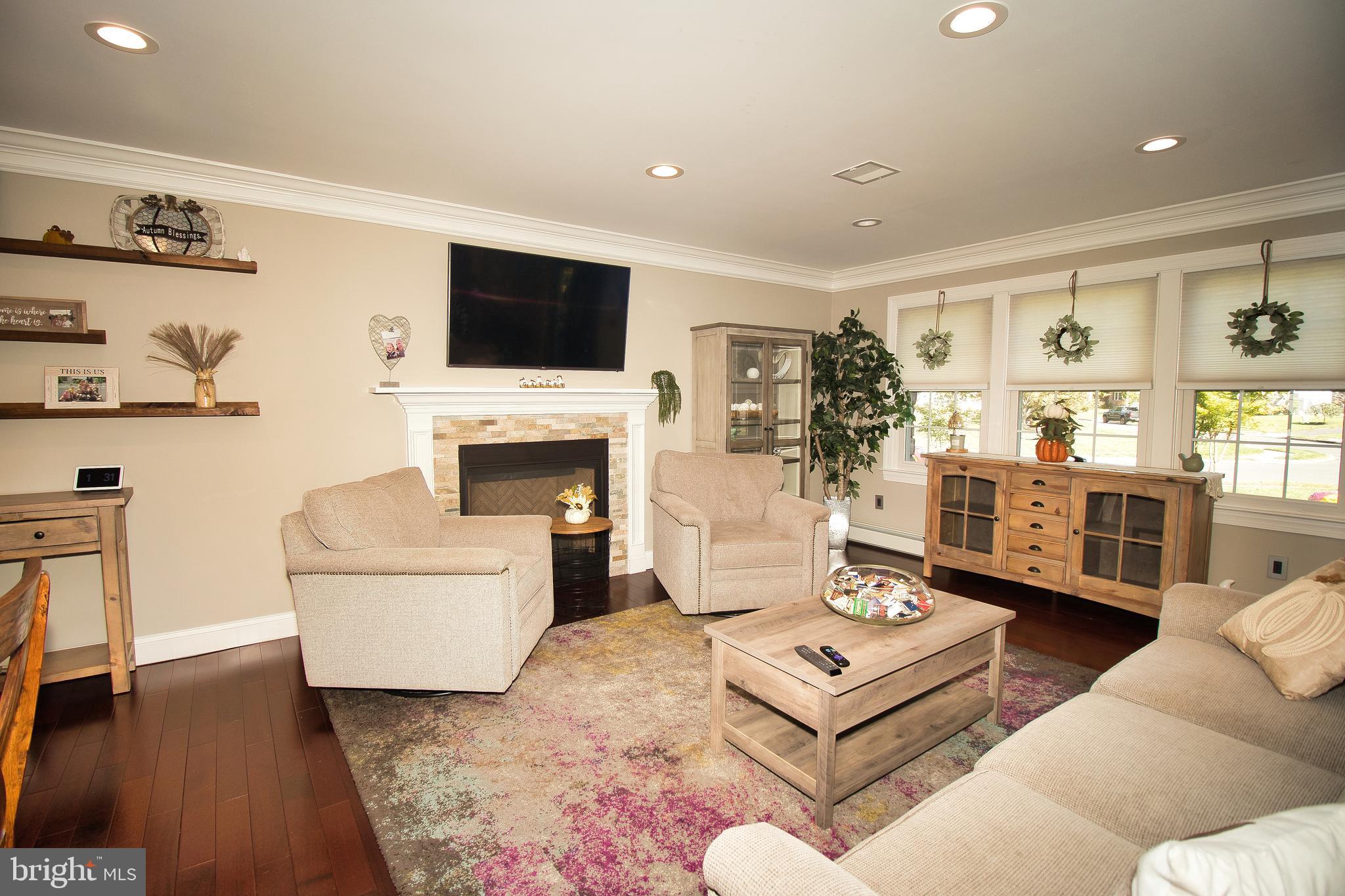 136 Washington Drive Warminster, PA 18974 - Photo 3 of 39 a living room with furniture a flat screen tv and a fireplace