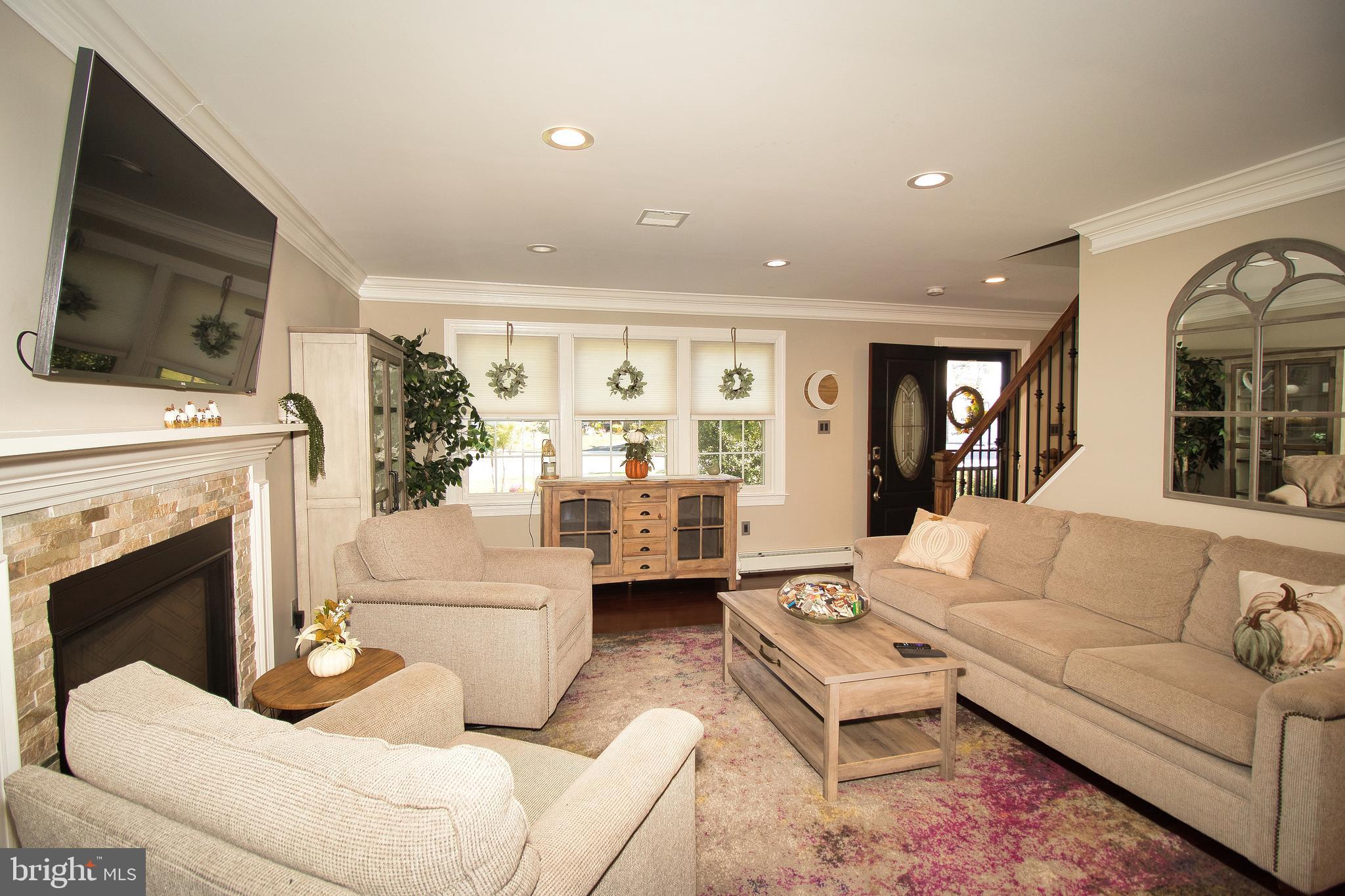 136 Washington Drive Warminster, PA 18974 - Photo 4 of 39 a living room with furniture a large window and a fireplace