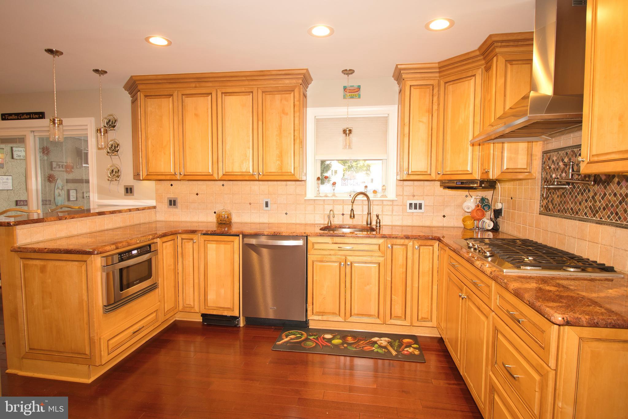 136 Washington Drive Warminster, PA 18974 - Photo 8 of 39 a kitchen with stainless steel appliances granite countertop a sink stove and refrigerator