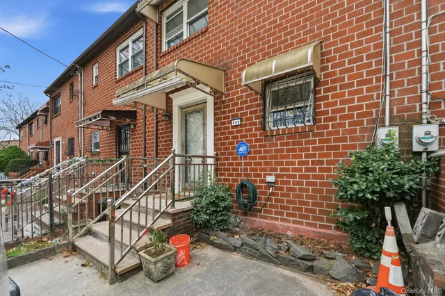 a view of a brick house with potted plants