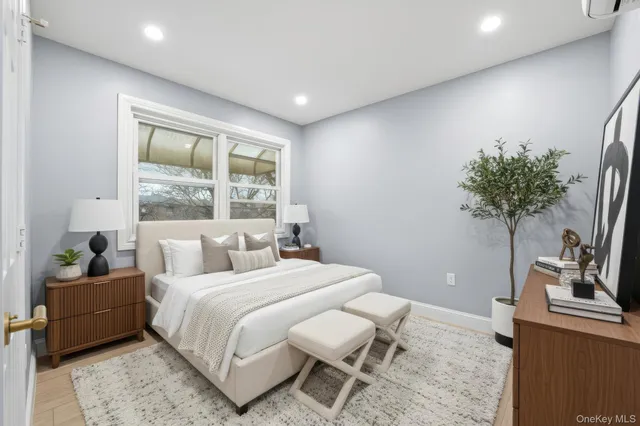 a bedroom with a bed and a potted plant