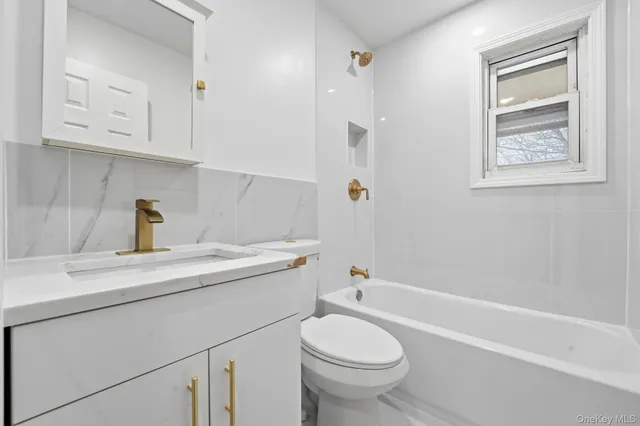 a bathroom with a sink toilet and vanity
