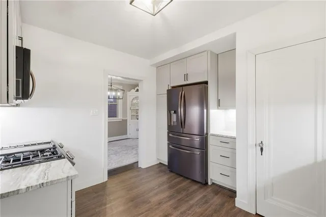 a kitchen with a refrigerator and a stove top oven