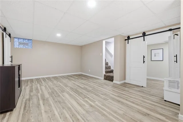 a spacious bathroom with a double vanity sink toilet and a mirror