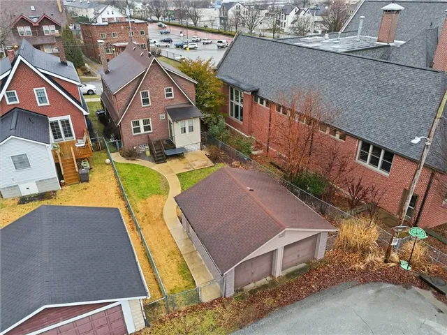 an aerial view of houses with yard