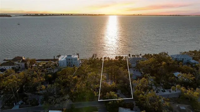 a view of a lake and a yard from a balcony