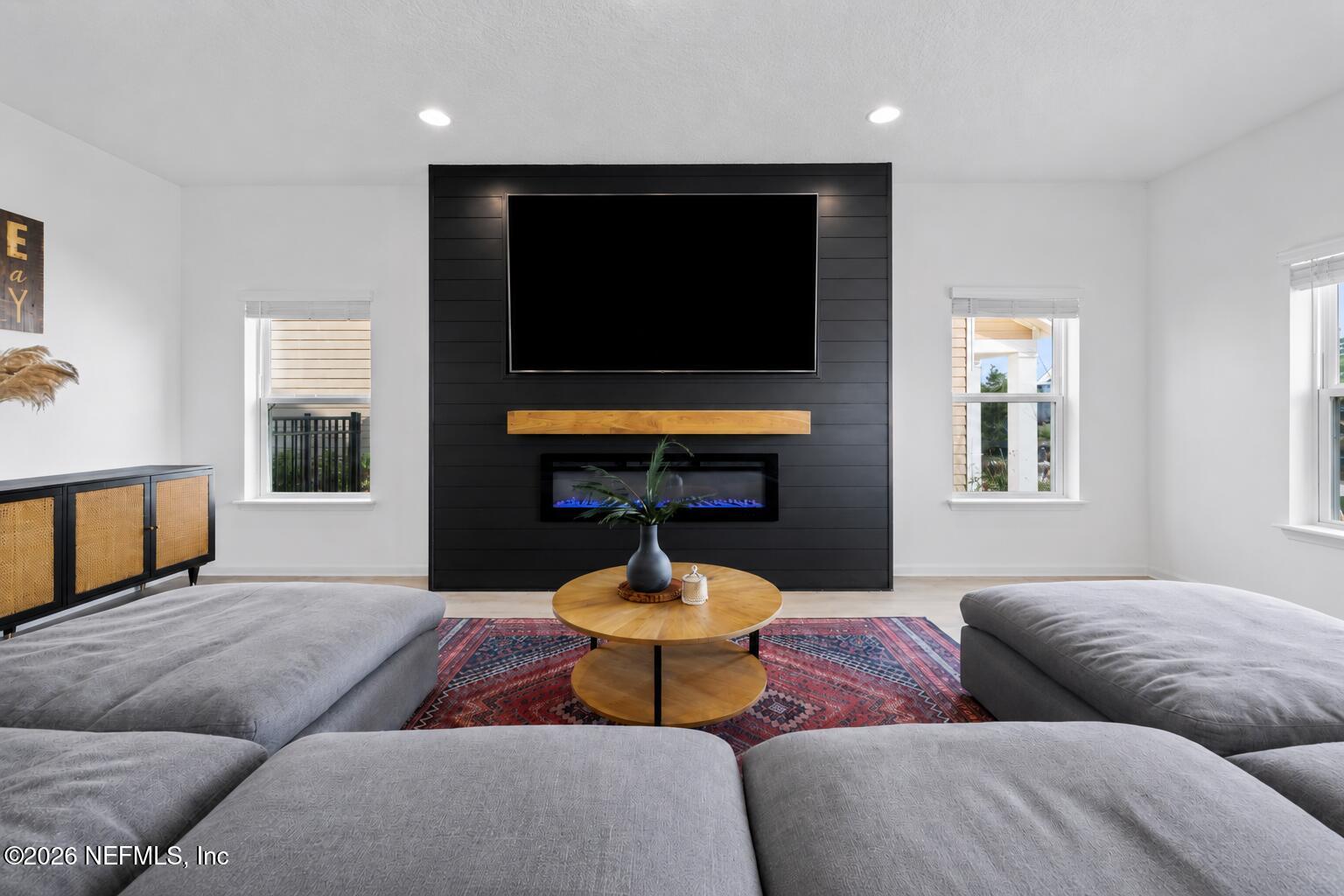 92 Patina Place St. Augustine, FL 32092 - Photo 8 of 26 a living room with fireplace furniture and a flat screen tv