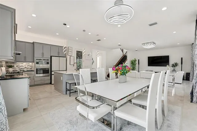 a large kitchen with a table and chairs