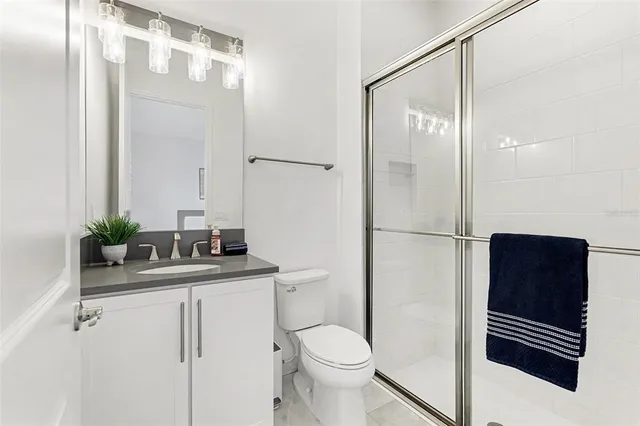 a bedroom with a bed and a ceiling fan