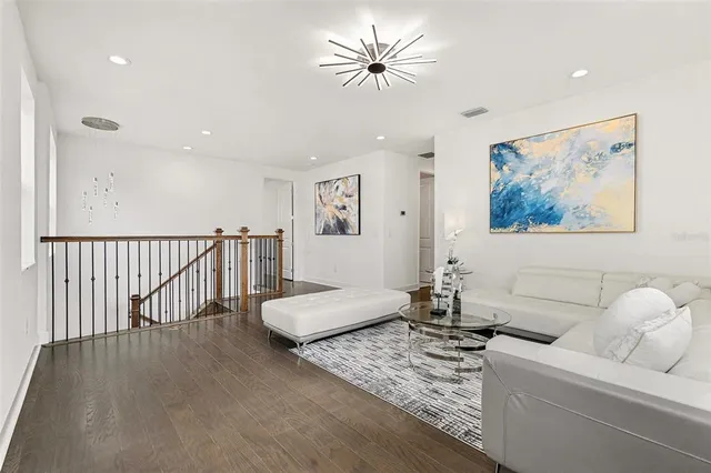 a spacious bedroom with a bed and a chandelier