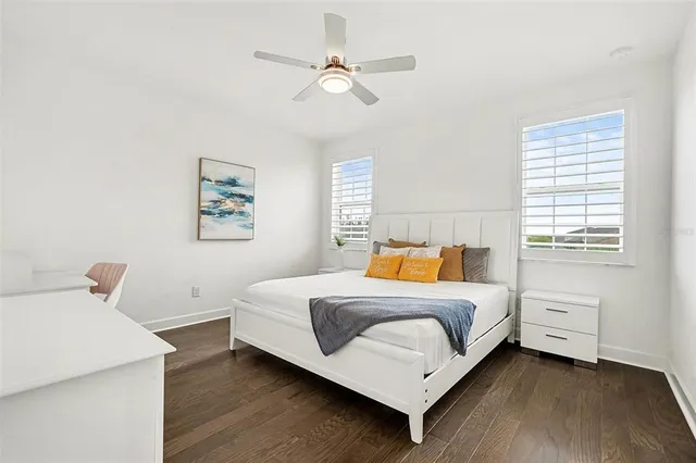 a bathroom with a granite countertop sink a toilet and bathtub