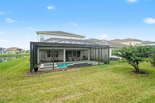 a view of a house with a yard from a lake view