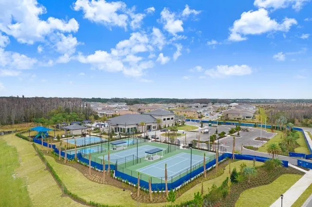 an aerial view of a house with outdoor space and lake view in back