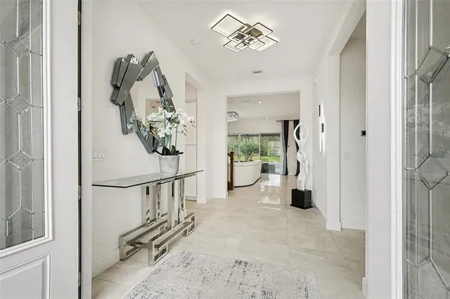 a large white kitchen with a large window and counter space