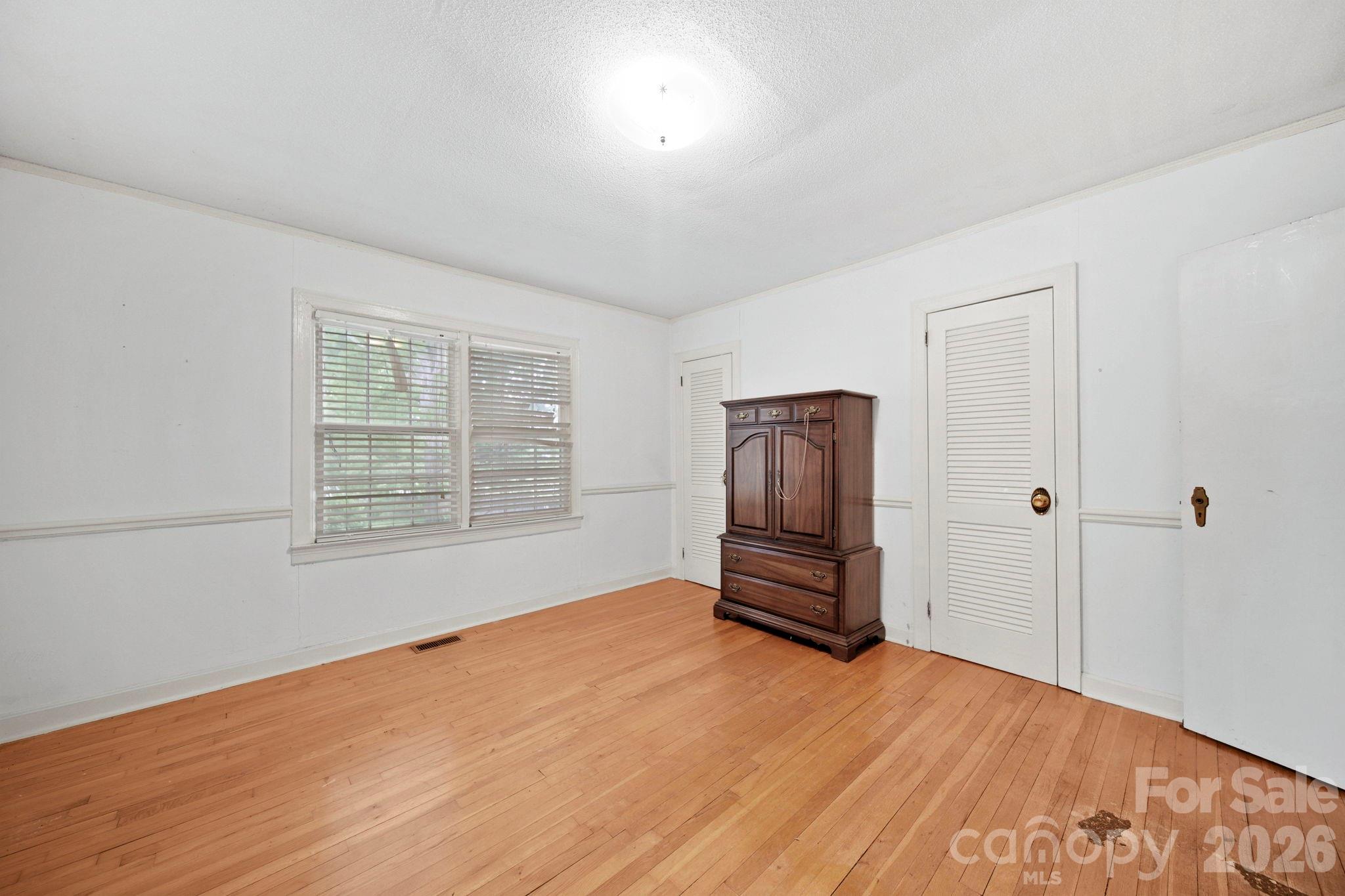 1109 Union Road Gastonia, NC 28054 - Photo 14 of 44 a view of empty room with wooden floor and window