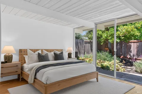 a bed sitting in a bedroom next to a window