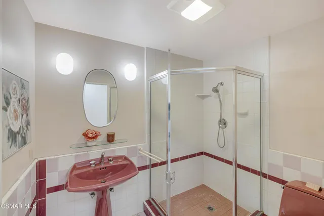 a bathroom with a sink mirror and vanity