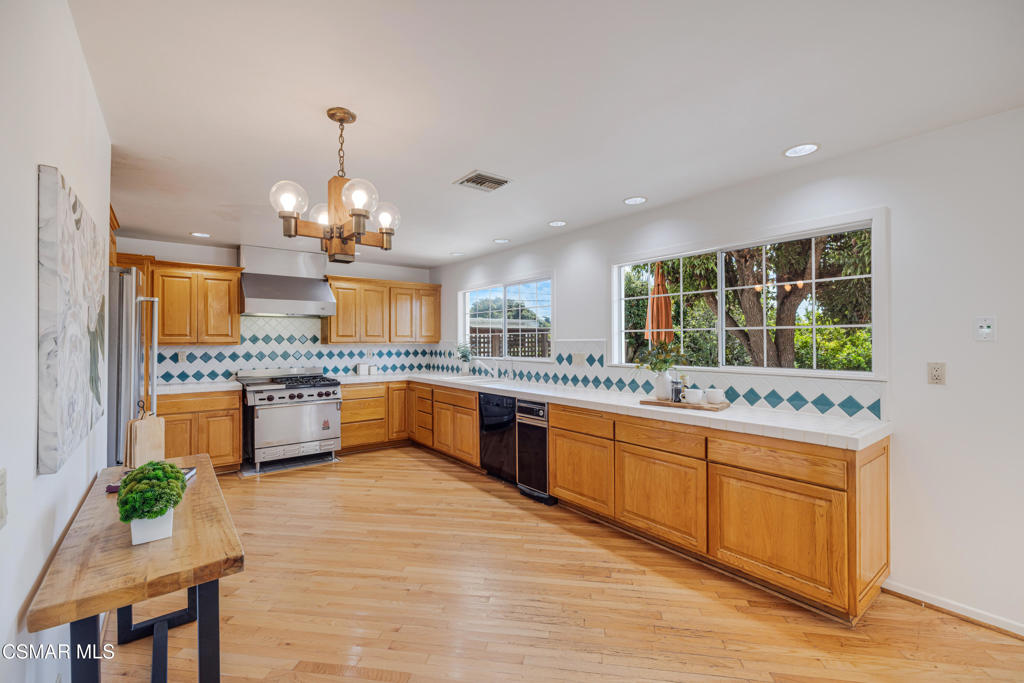 1884 Channel Drive Ventura, CA 93001 - Photo 16 of 62 a large kitchen with kitchen island a large counter top and stainless steel appliances