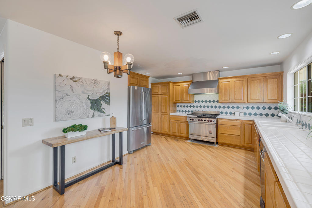 1884 Channel Drive Ventura, CA 93001 - Photo 17 of 62 a kitchen with granite countertop a stove a sink a refrigerator and wooden floor