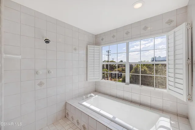 a spacious bathroom with a double vanity sink and a mirror