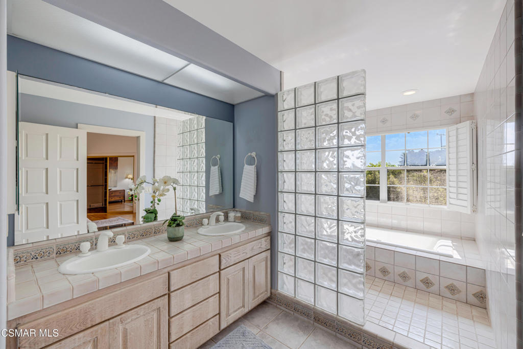 1884 Channel Drive Ventura, CA 93001 - Photo 33 of 62 a bathroom with a double vanity sink mirror and shower
