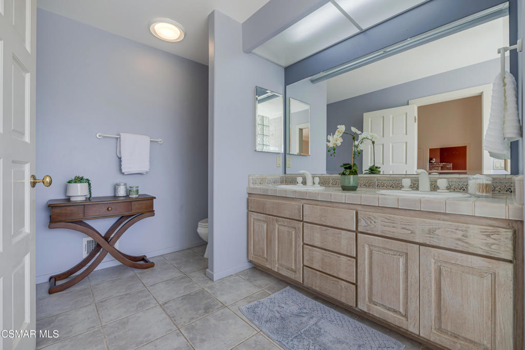 1884 Channel Drive Ventura, CA 93001 - Photo 34 of 62 a spacious bathroom with a double vanity sink and a mirror