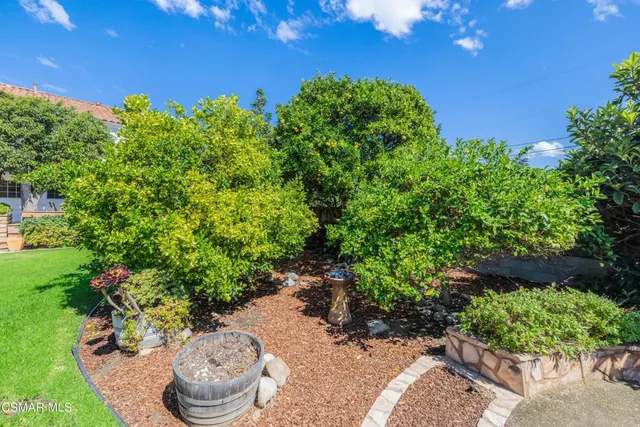 a view of a white house with a yard