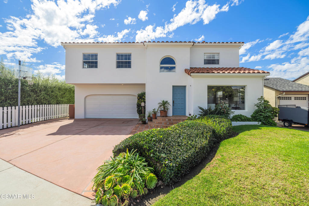 1884 Channel Drive Ventura, CA 93001 - Photo 5 of 62 a front view of a house with a yard and garage
