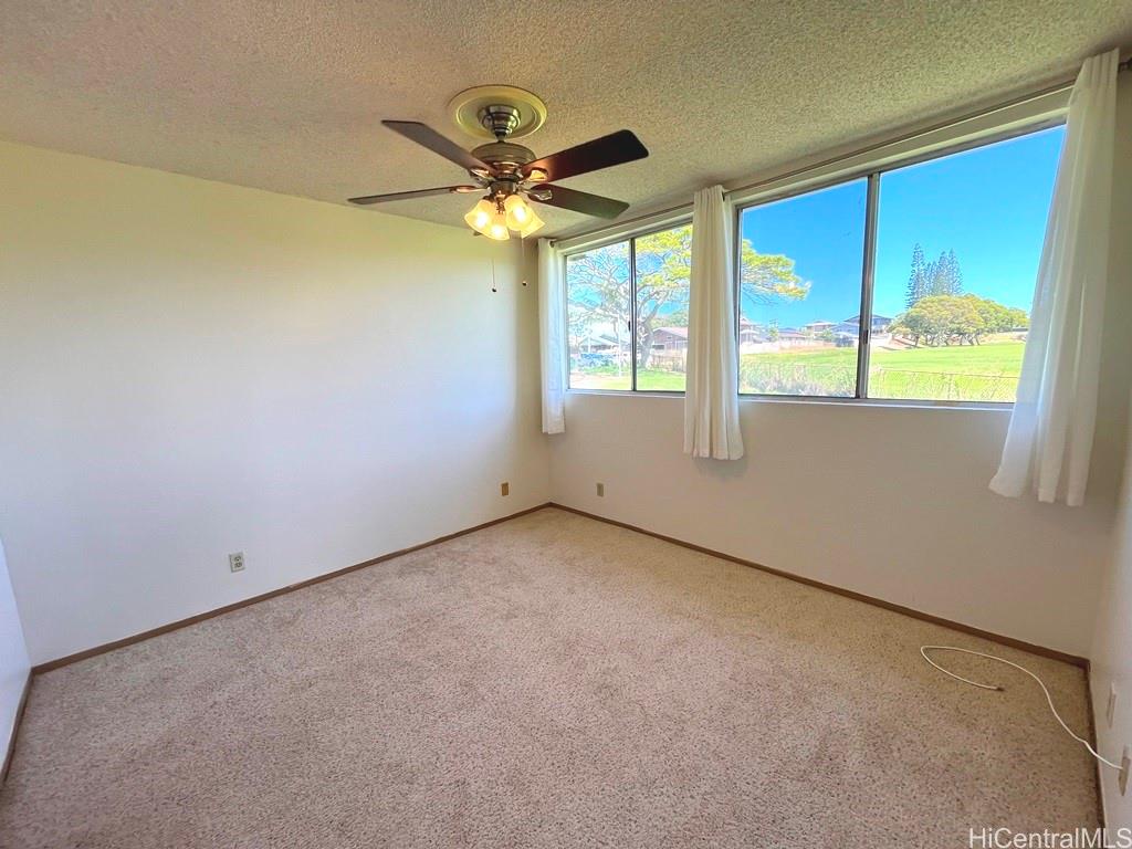 95-670 Hanile Street, Unit A102 Mililani, HI 96789 - Photo 8 of 13 an empty room with a window
