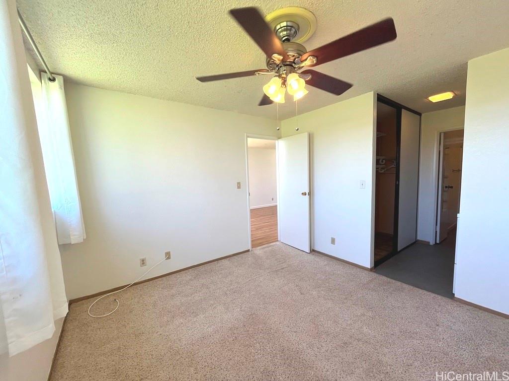95-670 Hanile Street, Unit A102 Mililani, HI 96789 - Photo 9 of 13 a view of an empty room with a fan