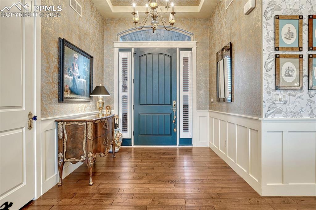 1935 Bashley Road Monument, CO 80132 - Photo 12 of 45 a view of a hallway with wooden floor and livingroom with fireplace