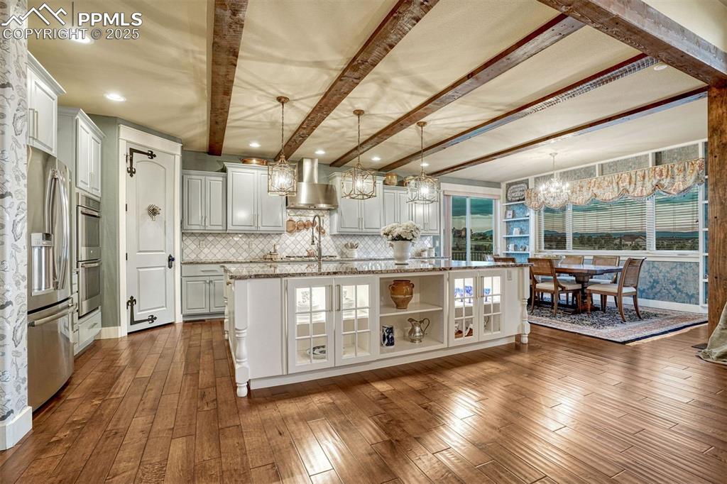1935 Bashley Road Monument, CO 80132 - Photo 15 of 45 a open kitchen with stainless steel appliances granite countertop a lot of counter space and wooden floors