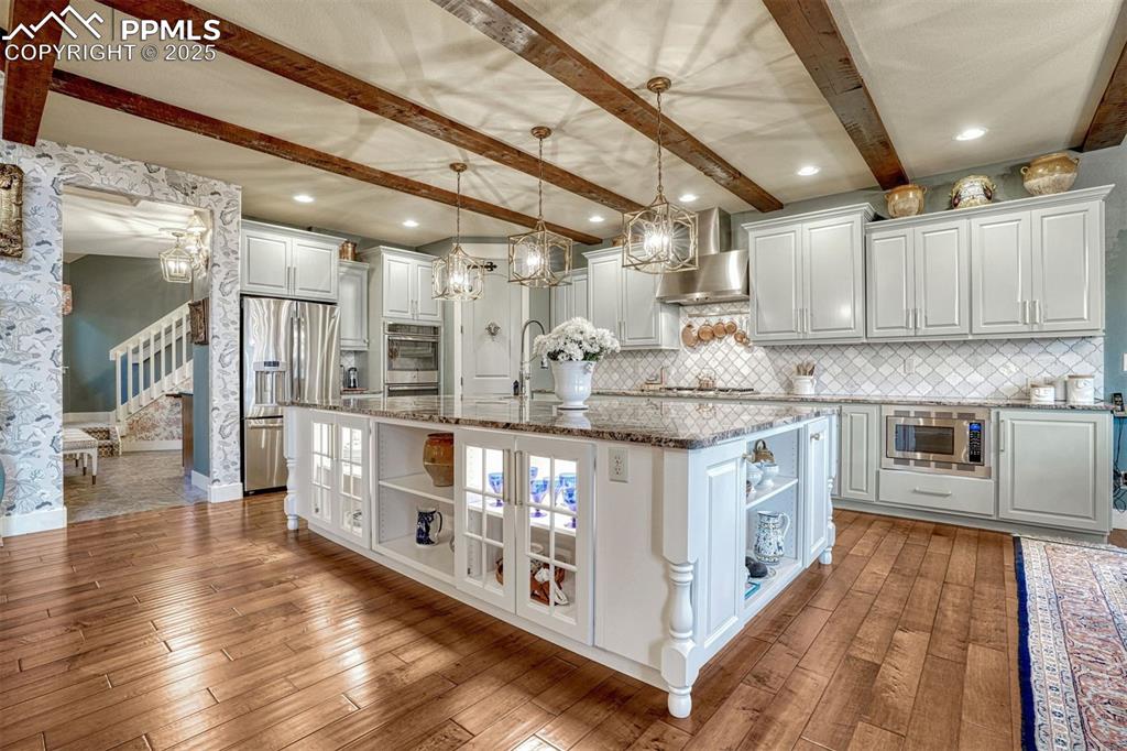 1935 Bashley Road Monument, CO 80132 - Photo 16 of 45 a kitchen with stainless steel appliances granite countertop a stove and cabinets