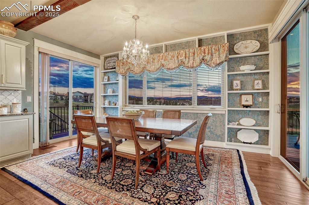 1935 Bashley Road Monument, CO 80132 - Photo 17 of 45 a view of a dining room with furniture a rug and wooden floor