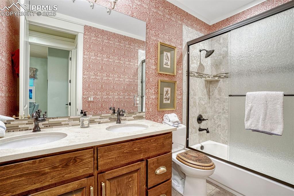 1935 Bashley Road Monument, CO 80132 - Photo 26 of 45 a bathroom with a double vanity sink toilet mirror and shower