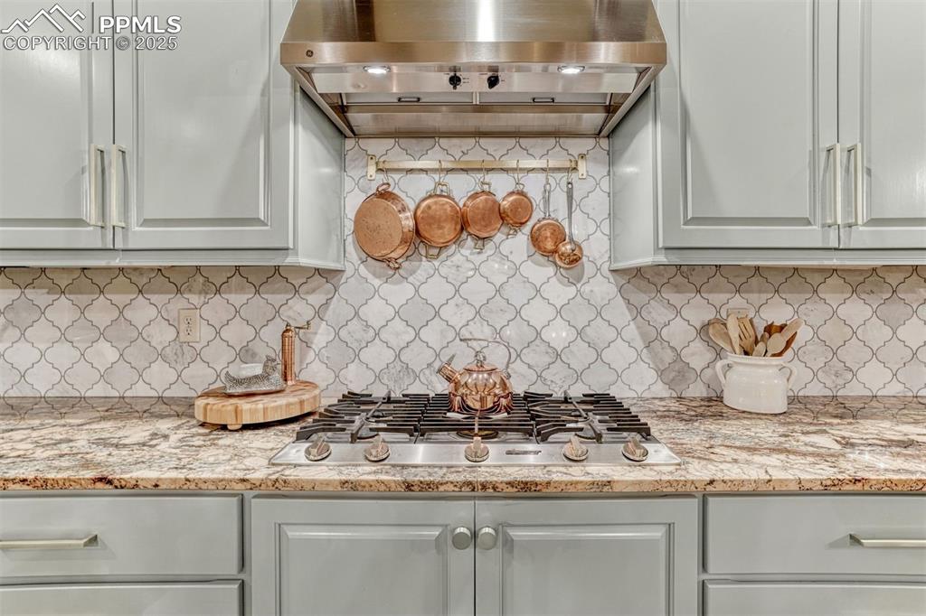 1935 Bashley Road Monument, CO 80132 - Photo 3 of 45 a kitchen with granite countertop white cabinets and a wooden floor