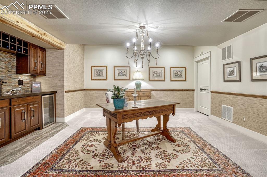 1935 Bashley Road Monument, CO 80132 - Photo 31 of 45 a living room with granite countertop furniture and a chandelier