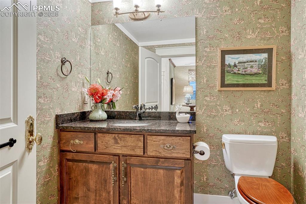 1935 Bashley Road Monument, CO 80132 - Photo 33 of 45 a bathroom with a toilet a sink and mirror
