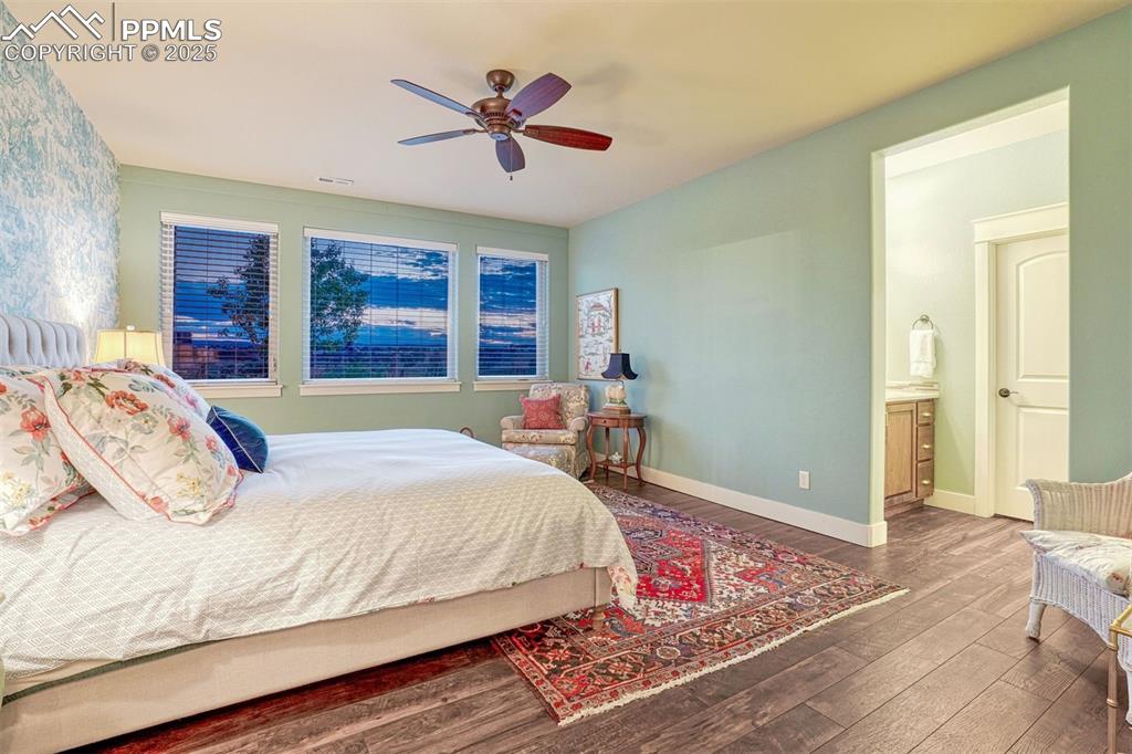 1935 Bashley Road Monument, CO 80132 - Photo 34 of 45 a bedroom with a large bed a chandelier and dresser