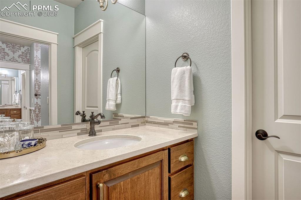 1935 Bashley Road Monument, CO 80132 - Photo 35 of 45 a bathroom with a sink vanity and a mirror