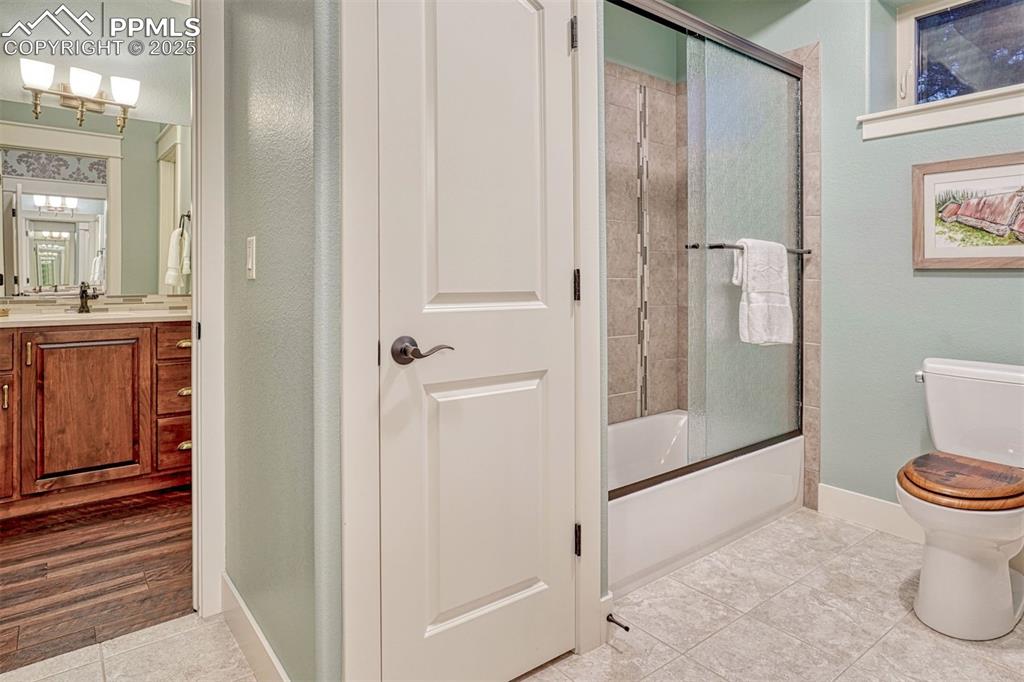 1935 Bashley Road Monument, CO 80132 - Photo 36 of 45 a bathroom with a granite countertop shower a toilet and a sink
