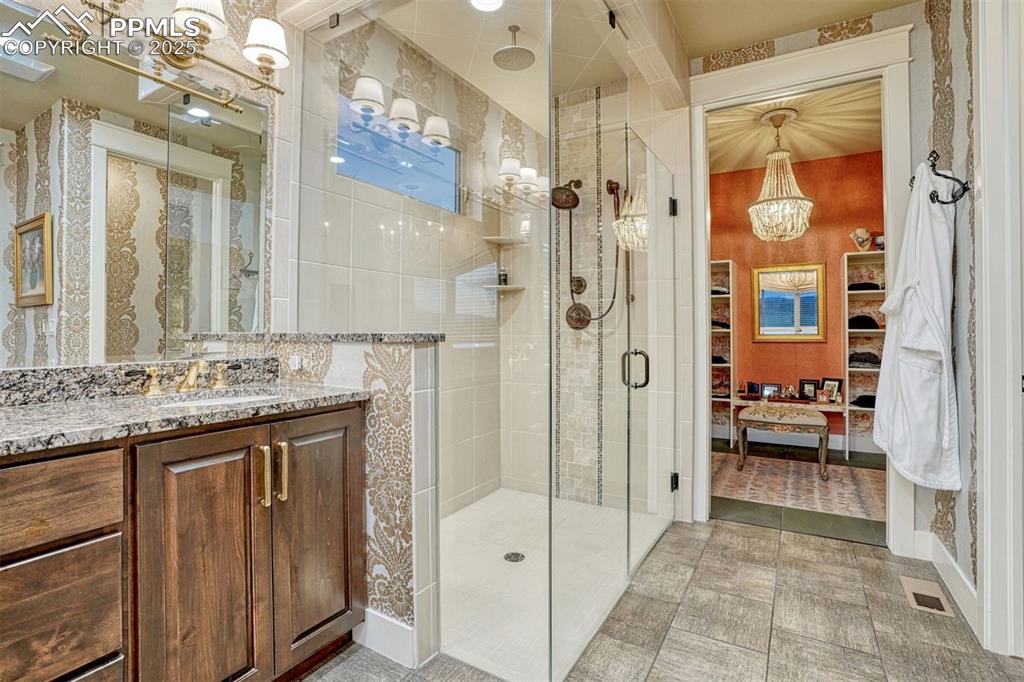 1935 Bashley Road Monument, CO 80132 - Photo 6 of 45 a bathroom with a granite countertop sink mirror and a shower