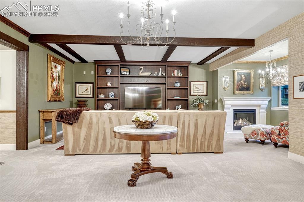 1935 Bashley Road Monument, CO 80132 - Photo 7 of 45 a living room with furniture a fireplace and a chandelier