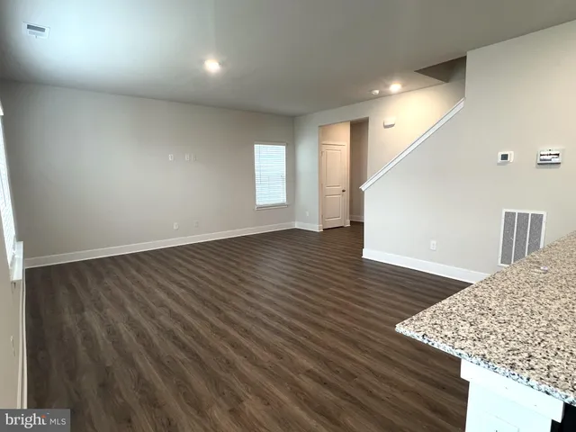 an empty room with wooden floor