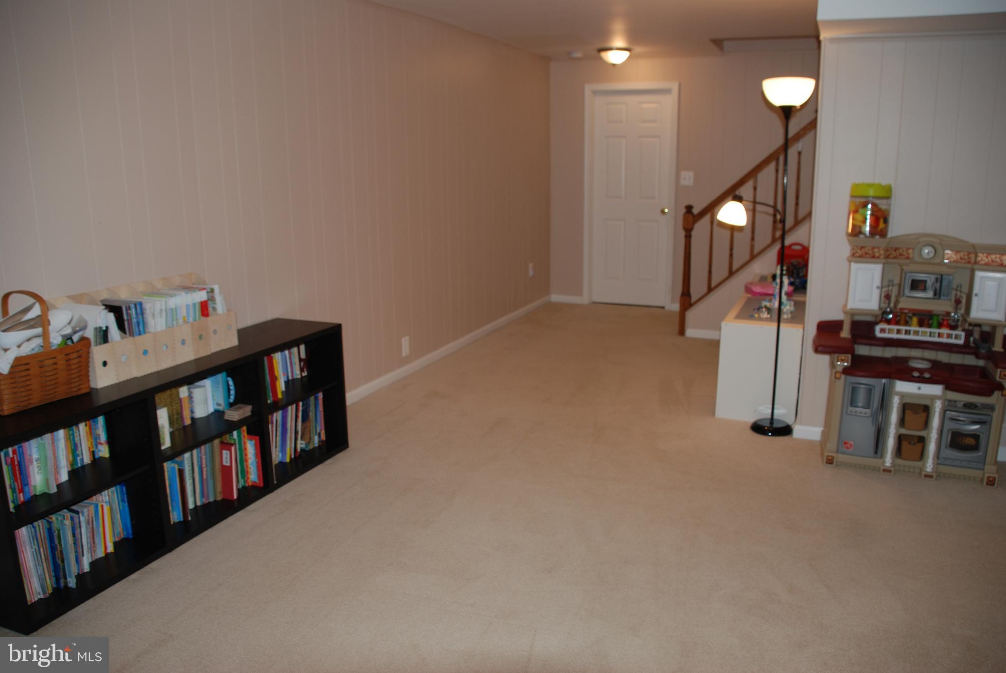 6108 Eagle Landing Road Burke, VA 22015 - Photo 41 of 52 The Great Room has neutral paneled walls & carpet