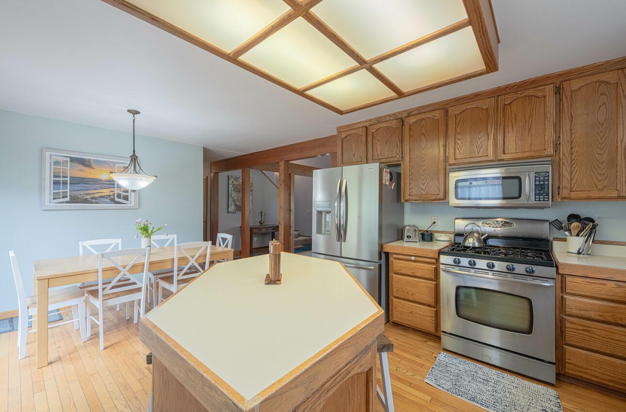 744 Seely Avenue Aromas, CA 95004 - Photo 27 of 55 a kitchen with a stove a sink and a refrigerator