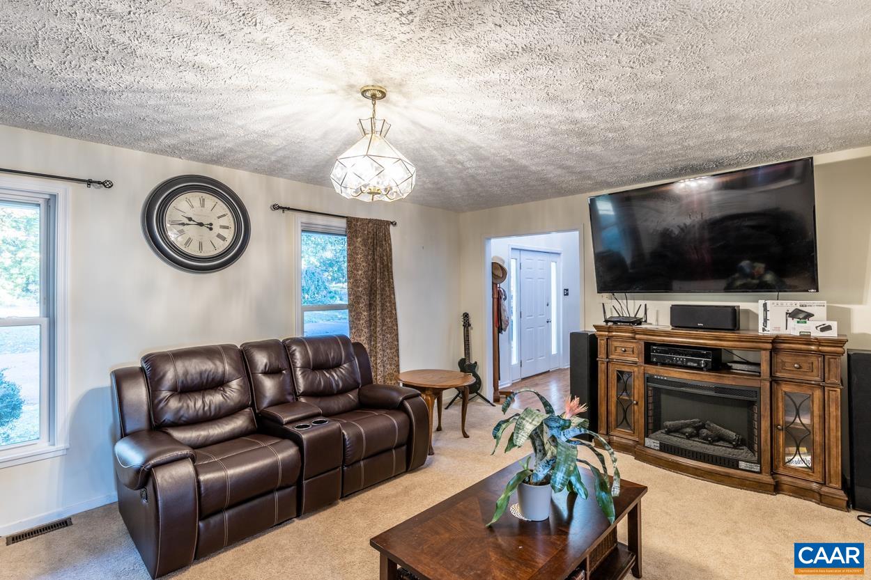 435 Courthouse Mountain Road Madison, VA 22727 - Photo 17 of 69 a living room with furniture and a flat screen tv