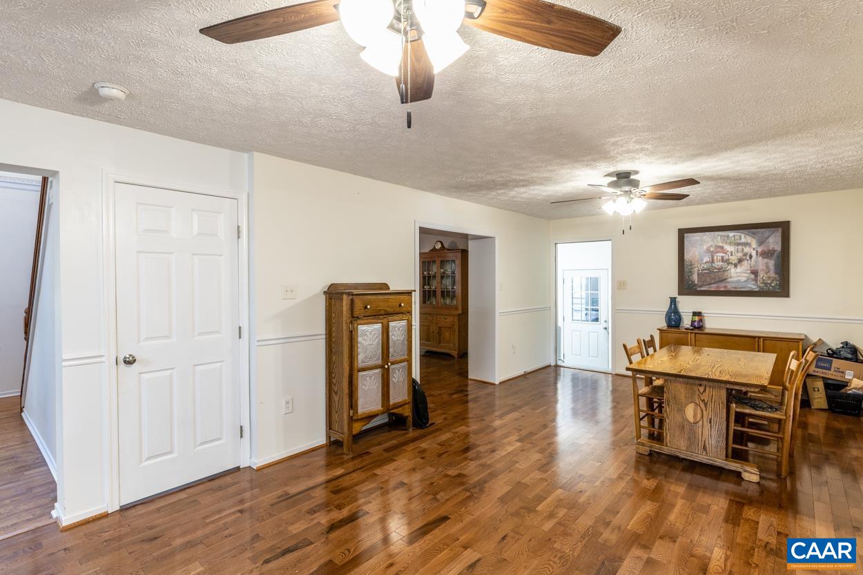 435 Courthouse Mountain Road Madison, VA 22727 - Photo 27 of 69 a living room with furniture and a chandelier